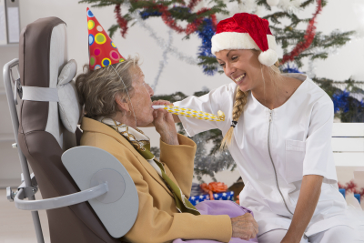 senior woman and her caregiver celebrating Christmas